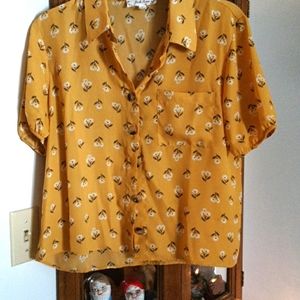 Yellow button up blouse.